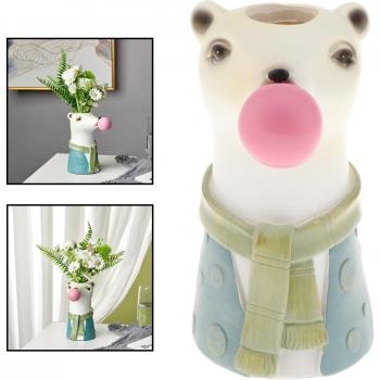Pot en forme d'animal avec plante bonsaï et fleurs séchées