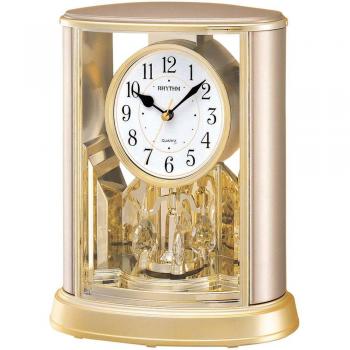 Reloj de mesa Rhythm Two Tone Oval con péndulo giratorio en oro